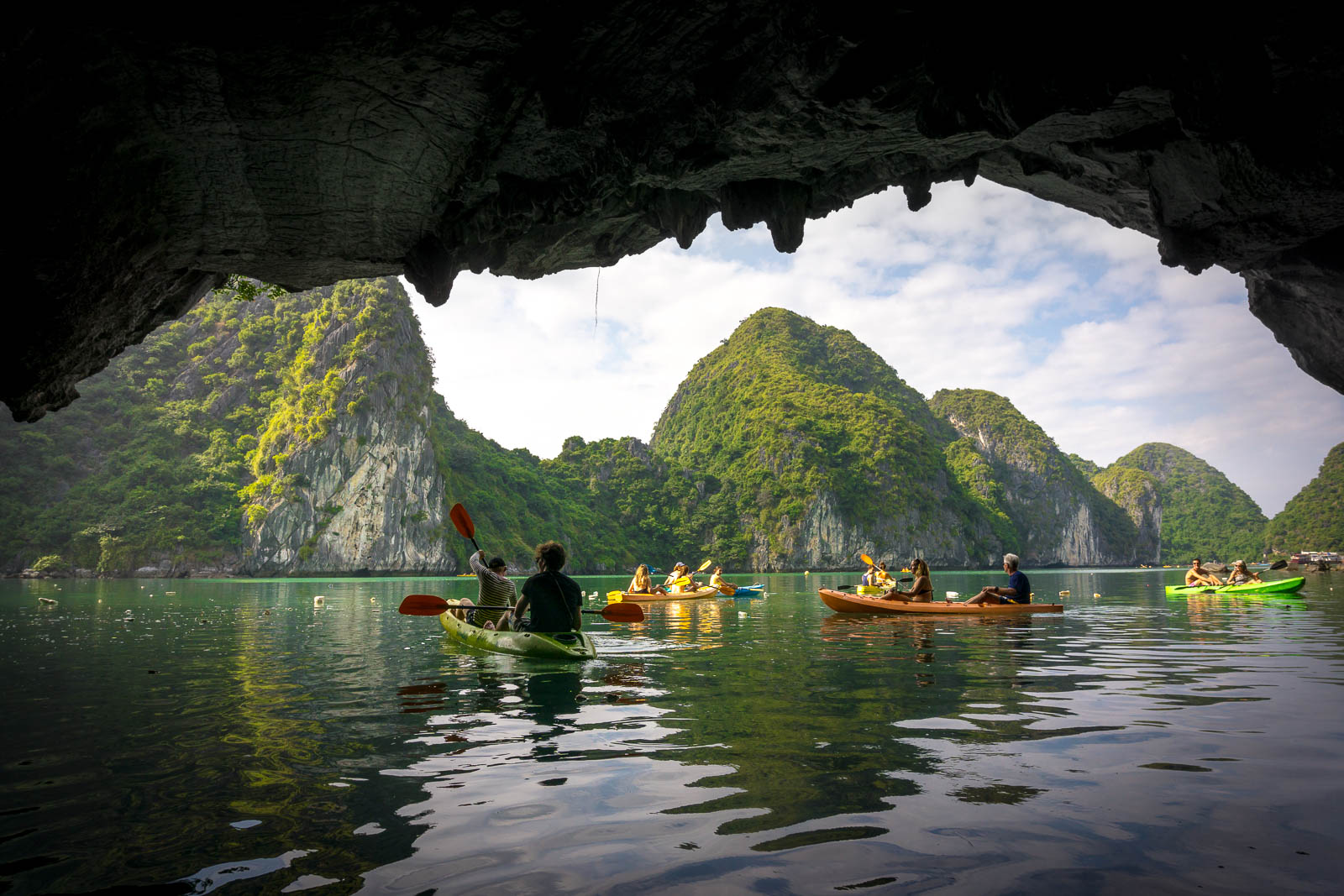 kayakers-going-through-cave-in-ha-long-bay.jpg